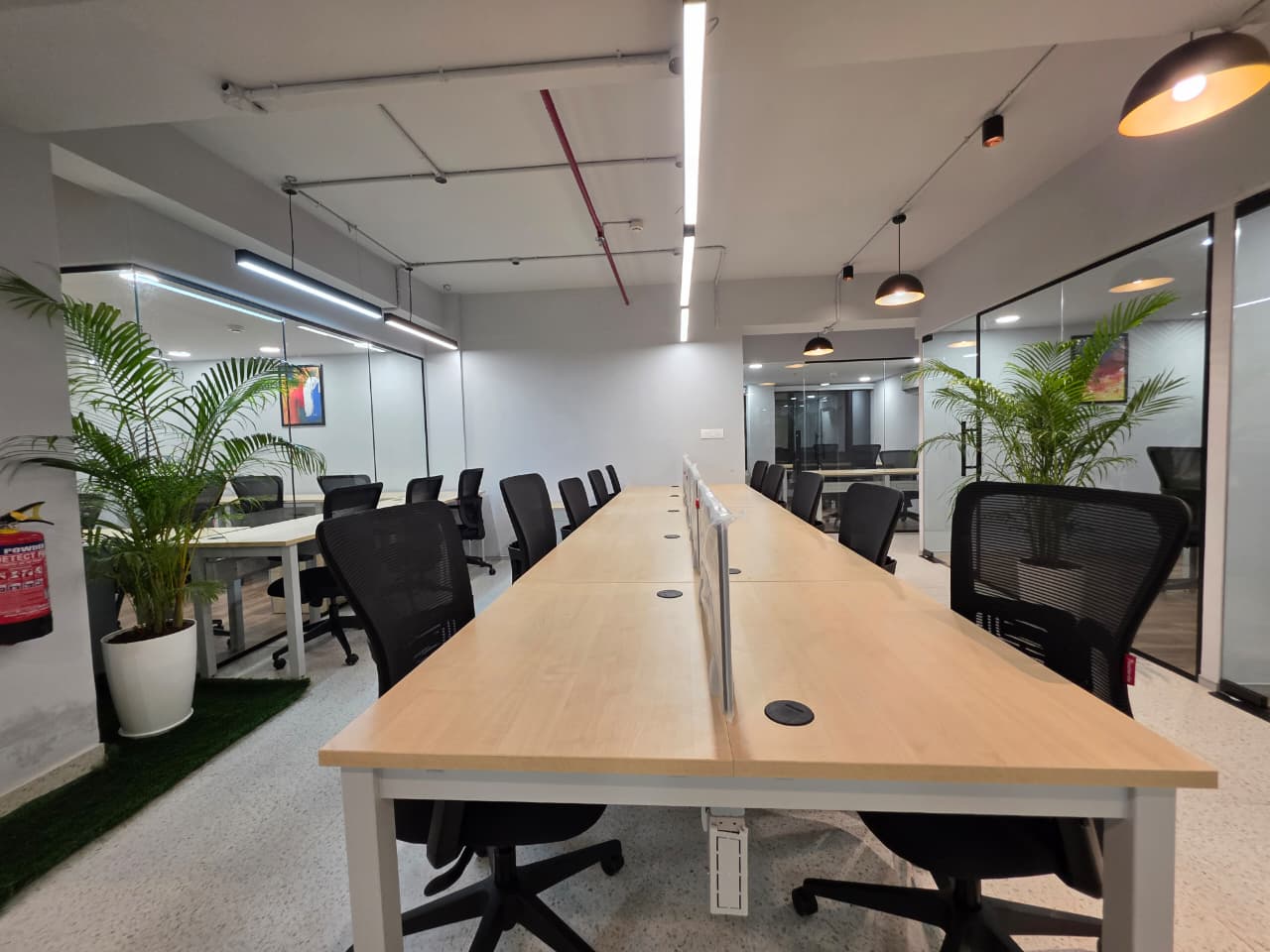 Eternal Coworking — main floor with hot desks and meeting rooms